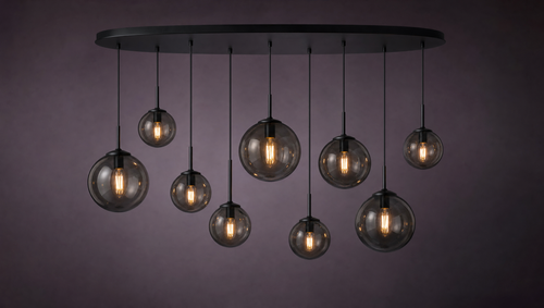 Nine smoked glass globes at varying heights from a long oval black canopy